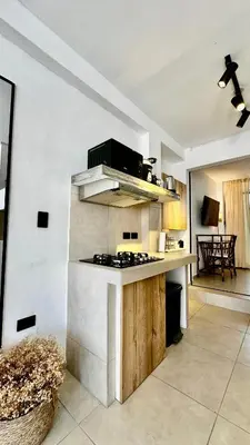 a kitchen with a stove top oven in a room at Apartamentos Boho in Punta Hermosa