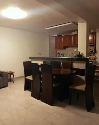 a kitchen and dining room with a table and chairs at Colibrí12 in Lima