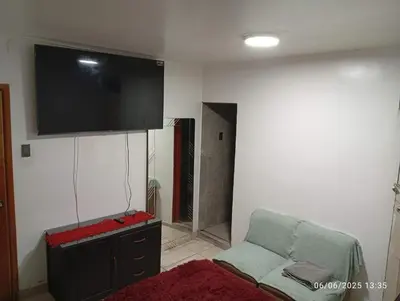 a living room with a couch and a flat screen tv at Colibrí12 in Lima