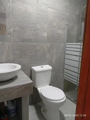 a bathroom with a toilet and a sink at Colibrí12 in Lima
