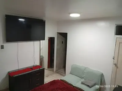 a living room with a couch and a flat screen tv at Colibrí12 in Lima