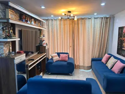 a room with two blue chairs and a desk at Departamento Palmeras in Lima