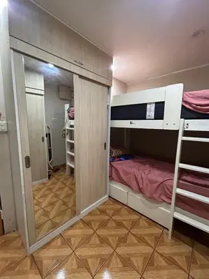 a small room with a bunk bed and a mirror at Departamento Palmeras in Lima