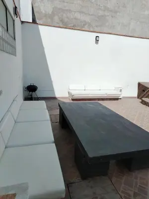 a room with a black table and white benches at Casa 4 DORM - 3 VISTAMAR, 14 a 20 pax piscina propia in San Bartolo