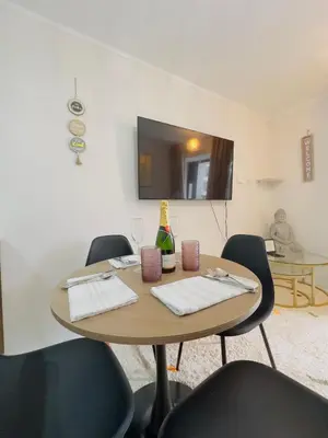 a dining room with a wooden table and chairs at APPARTEMENT CHIC MIRAFLORES Paradis in Lima