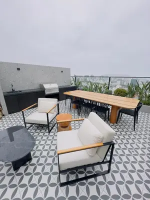 a patio with chairs and a table on a roof at APPARTEMENT CHIC MIRAFLORES Paradis in Lima