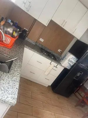 an overhead view of a kitchen with white cabinets at Quiet room in Lima