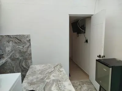 a bathroom with a counter and a sink in a room at Habitación independiente con terraza y cocina in Lima