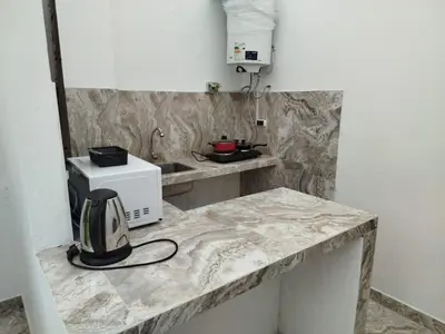 a kitchen with a counter top with a microwave at Habitación independiente con terraza y cocina in Lima