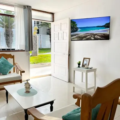 a living room with a white door and a table at Direct Beach Access Apt & Speedy WiFi in Punta Hermosa