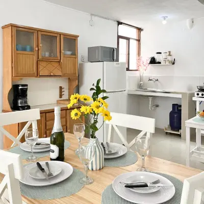 a dining room table with plates and wine glasses at Direct Beach Access Apt & Speedy WiFi in Punta Hermosa
