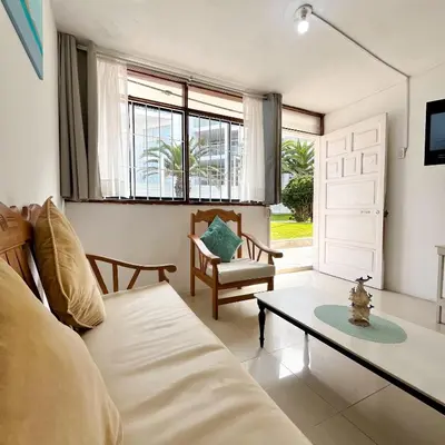 a living room with a couch and a table at Direct Beach Access Apt & Speedy WiFi in Punta Hermosa