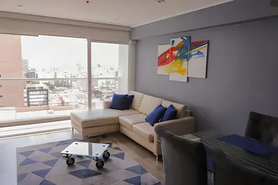 a living room with a couch and a table at Apartment in the most touristy area of Miraflores in Lima