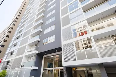 a facade of a building with large windows at Apartment in the most touristy area of Miraflores in Lima