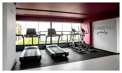 a gym with several tread machines in a room at Fantastic New Apartment with Rooftop Pool and Gym in San Isidro in Lima