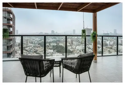 a table and chairs on a balcony with a view at Fantastic New Apartment with Rooftop Pool and Gym in San Isidro in Lima