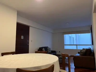 a room with a table and chairs and a window at Villaflores Apartments in Lima