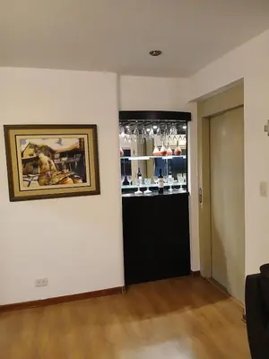 a room with a picture on the wall and a wine cellar at Miraflores ocean view in Lima