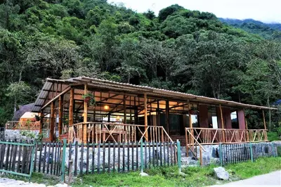 a house under construction in front of a mountain at Salkantay Majestic Domes Eco Lodge in Sahuayacu