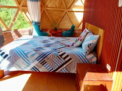 a bedroom with a bed in a room at Salkantay Majestic Domes Eco Lodge in Sahuayacu