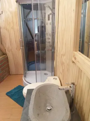 a bathroom with a shower with a toilet and a sink at Salkantay Majestic Domes Eco Lodge in Sahuayacu