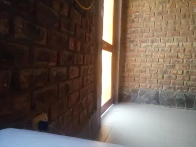 an empty room with a brick wall and a window at Babylon Mansion in Nazca