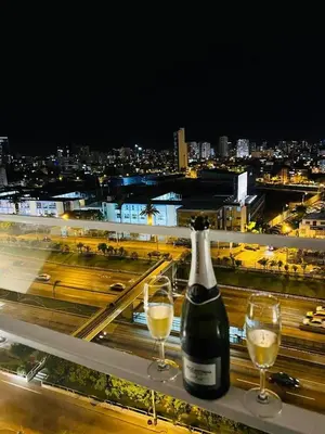 a bottle of wine and two glasses on a ledge at VIP Apartment TORRE TEMPO in Lima