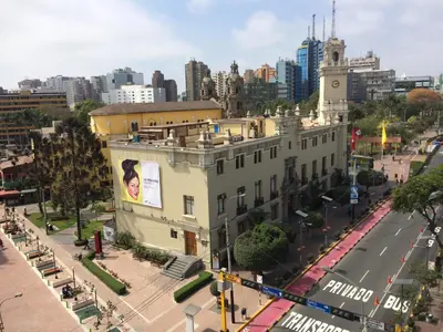 an aerial view of a city with a building at Larq'a Park Rooms in Lima