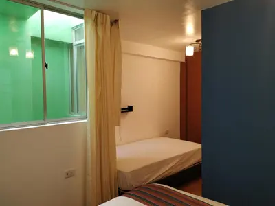 a small bedroom with a bed and a window at La Casa de Justi in Huancayo