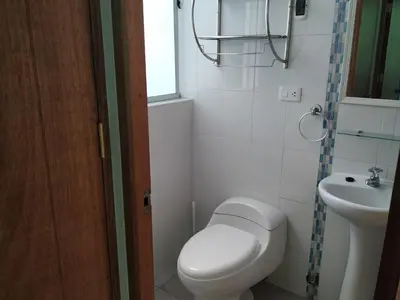 a small bathroom with a toilet and a sink at La Casa de Justi in Huancayo