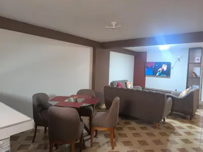 a waiting room with chairs and a table and a couch at Suites Tintaya in Cusco