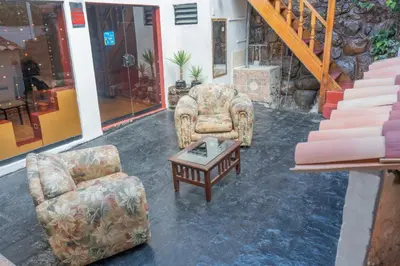 a living room with two chairs and a coffee table at CHARMING AND QUIET apart IN CUSCO in Cusco