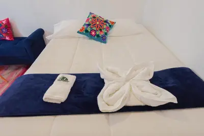 a bed with towels and pillows on it at CHARMING AND QUIET apart IN CUSCO in Cusco