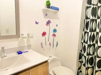 a bathroom with a sink and a toilet and a mirror at Departamento exclusivo con vista a la ciudad in Lima