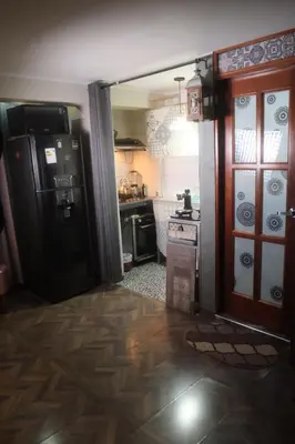 a kitchen with a black refrigerator and a stove at Hermoso mini dpto en San Luis Lima in Lima