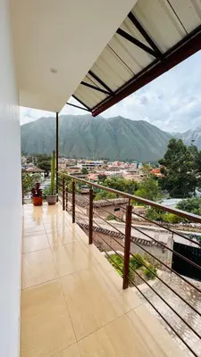 a balcony with a view of a city and mountains at Yoga Home in Urubamba