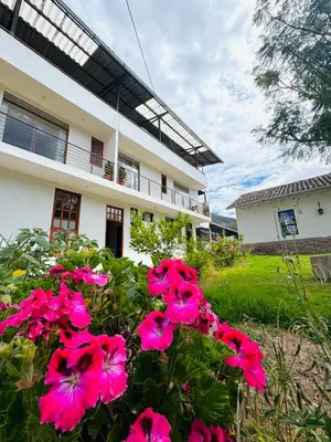 a house with pink flowers in front of it at Yoga Home in Urubamba