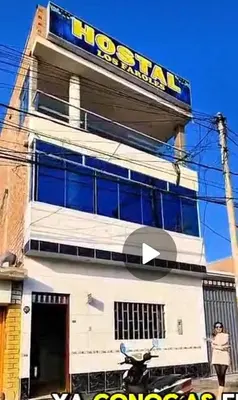 a building with a hooters sign on it at Hostal los Faroles in Barranca