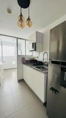 a kitchen with a stainless steel refrigerator and a sink at A 15 minutos del aeropuerto cómodo y moderno departamento de 3 habitaciones independientes y 2 baños in Lima