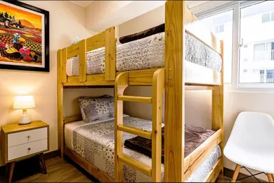 a bunk bed room with two bunk beds and a desk at Premium Miraflores Stay with Pool and Amenities in Lima