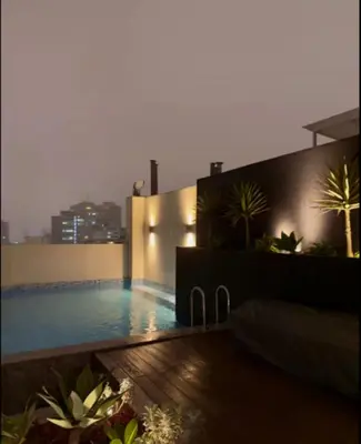 a swimming pool on the side of a building at Premium Miraflores Stay with Pool and Amenities in Lima