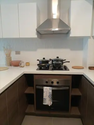 a kitchen with two pots and pans on a stove at Cozy apartment by Parque Kennedy, Miraflores in Lima