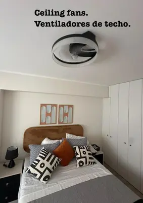 a bedroom with a bed with a light on the ceiling at Cozy apartment by Parque Kennedy, Miraflores in Lima