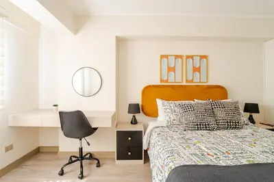 a bedroom with a bed and a desk and a chair at Cozy apartment by Parque Kennedy, Miraflores in Lima