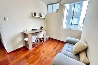 a living room with a desk and a couch at Cosy place retreat Miraflores 3BR in Lima