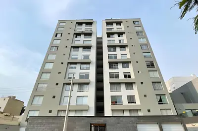 a tall apartment building in front of a blue sky at Cosy place retreat Miraflores 3BR in Lima