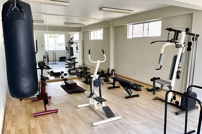 a gym with a lot of exercise equipment at Cosy place retreat Miraflores 3BR in Lima
