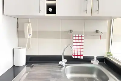 a kitchen counter with a sink and a phone at Cosy place retreat Miraflores 3BR in Lima