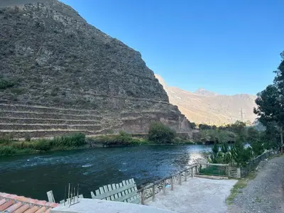 a river with a mountain in the background at Bed and Breakfasts - Ollantaytambo by ViaHero in Ollantaytambo