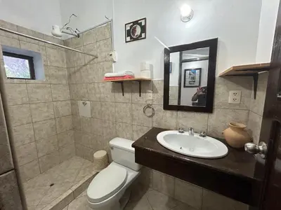 a bathroom with a sink and a toilet and a mirror at Bed and Breakfasts - Ollantaytambo by ViaHero in Ollantaytambo